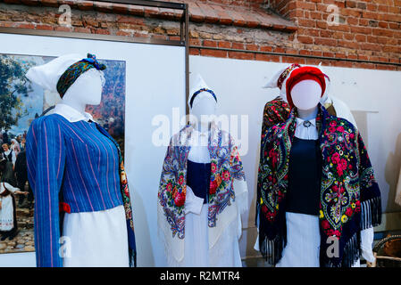 Latvian traditional costumes. Exhibition of Arts and crafts 'Creative Dominance'. National cultural identity. St. Peter's Church is a Lutheran church  Stock Photo