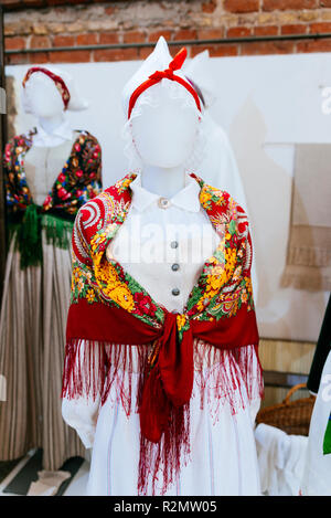 Latvian traditional costumes. Exhibition of Arts and crafts 'Creative Dominance'. National cultural identity. St. Peter's Church is a Lutheran church  Stock Photo
