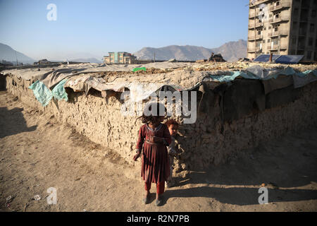 (181120) -- KABUL, Nov. 20, 2018 (Xinhua) -- Afghan children stand outside their mud houses on World Children's Day in Kabul, capital of Afghanistan, Nov. 20, 2018. The United Nations Children's Fund (UNICEF) office in Afghanistan said on Monday that about 3.7 million Afghan children have no access to school due to insecurity and poverty in the country. (Xinhua/Rahmat Alizadah) Stock Photo