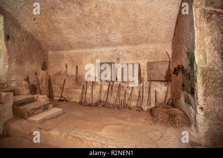 MATERA, ITALY -JULY 2016: old cavern house in Materia, reconstruction of how families lived in that house Stock Photo