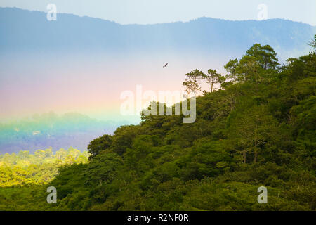 A rainbow forms in a valley near the pyramid of the Mayan ruins of Tonina, Chiapas, Mexico. Stock Photo