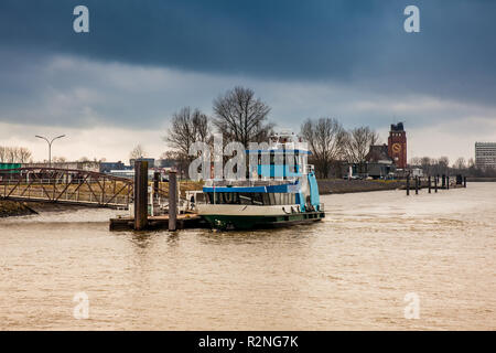 Ferry navigating on the Elbe river in a cold cloudy winter day in Hamburg Stock Photo