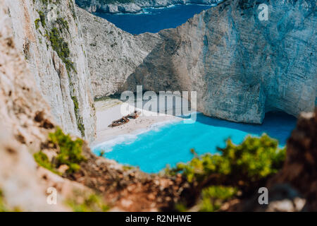 Famous shipwreck on Navagio beach with turquoise blue sea water surrounded by huge white cliffs. Famous landmark location on Zakynthos island, Greece. Nature framed Stock Photo