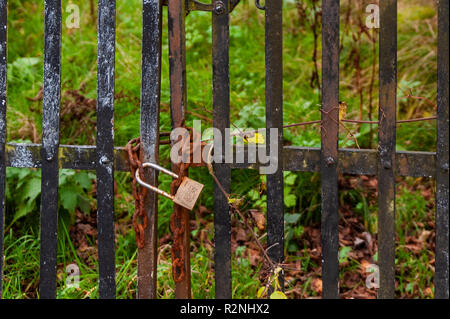 Padlocked and chained gates with rusty chain in Ireland. Stock Photo