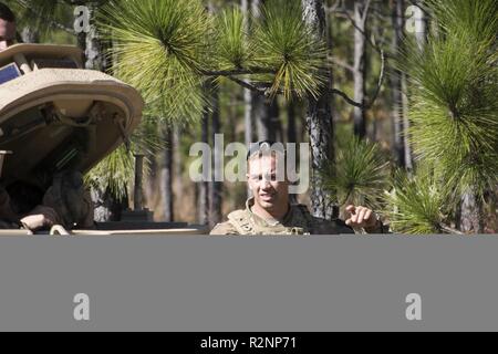 South Carolina Army National Guard Soldiers from 4th Battlion, 118th Regiment and 174th Engineer Company conduct combined arms breaching exercises at McCrady Training Center, Eastover, S.C., Nov. 3, 2018.  The 4th Battalion infantry companies practiced attacking an objective using support from the 174th engineer mobility assault platoons for obstacle reduction, destruction and short-gap crossings.  The combined forces breached wired obstacles using simulated M58 Mine Clearing Line Charge (MICLIC) rockets, cleared minefields with an M9 Armored Combat Earthmover (ACE), and placed a bridge over a Stock Photo