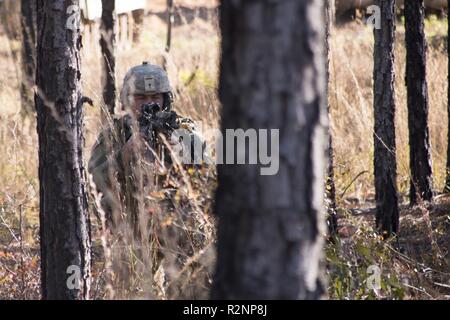 South Carolina Army National Guard Soldiers from 4th Battlion, 118th Regiment and 174th Engineer Company conduct combined arms breaching exercises at McCrady Training Center, Eastover, S.C., Nov. 3, 2018.  The 4th Battalion infantry companies practiced attacking an objective using support from the 174th engineer mobility assault platoons for obstacle reduction, destruction and short-gap crossings.  The combined forces breached wired obstacles using simulated M58 Mine Clearing Line Charge (MICLIC) rockets, cleared minefields with an M9 Armored Combat Earthmover (ACE), and placed a bridge over a Stock Photo