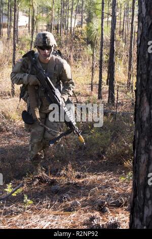 South Carolina Army National Guard Soldiers from 4th Battlion, 118th Regiment and 174th Engineer Company conduct combined arms breaching exercises at McCrady Training Center, Eastover, S.C., Nov. 3, 2018.  The 4th Battalion infantry companies practiced attacking an objective using support from the 174th engineer mobility assault platoons for obstacle reduction, destruction and short-gap crossings.  The combined forces breached wired obstacles using simulated M58 Mine Clearing Line Charge (MICLIC) rockets, cleared minefields with an M9 Armored Combat Earthmover (ACE), and placed a bridge over a Stock Photo