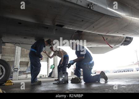 Airmen from the 44th Aircraft Maintenance Unit load AIM-9 Sidewinder ...