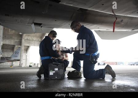 Airmen from the 44th Aircraft Maintenance Unit load AIM-9 Sidewinder ...