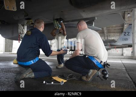 Airmen from the 44th Aircraft Maintenance Unit load AIM-9 Sidewinder ...