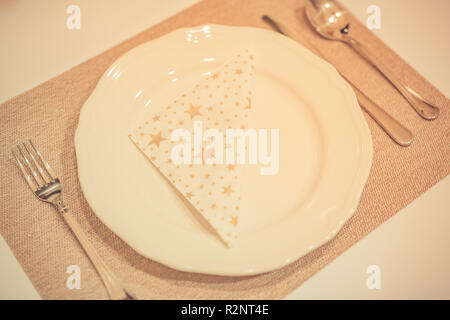 Holiday table place setting, top view. Vintage toned effect Stock Photo