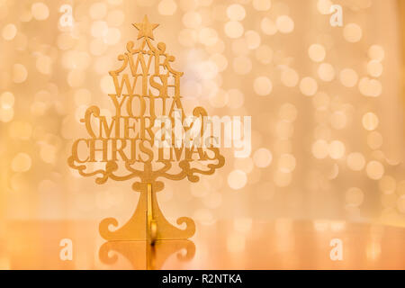 Wooden tree with inscription We Wish you a merry Christmas, Christmas decoration Stock Photo