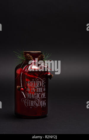 Motivational jar Believe in the magic of Christmas. Inspirational December gift for seasonal holiday Stock Photo