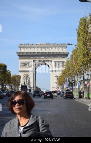 Paris, France - 2018: Women in the middle of the Avenue des Champs-Élysées in front of the Arc de Triomphe in Paris; Stock Photo