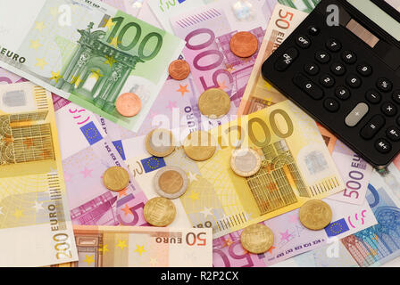 euro banknotes,coins and pocket calculator Stock Photo