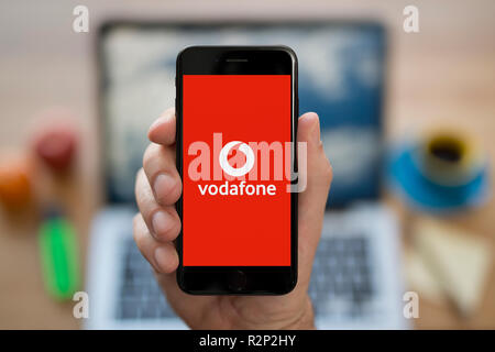 a-man-looks-at-his-iphone-