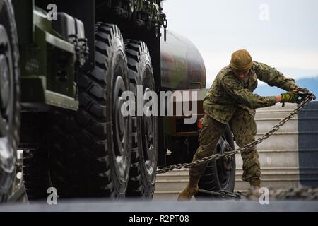 Lcac Loading U.S. Marines remove securing chains from an M1A1 main battle tank in ...