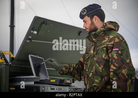 Dutch Sergeant Noordermeer checking the RACE 1 equipment. 1 German/Netherlands Corps' Communication and Information Systems Battalion is responsible for the communication between the Headquarters and its brigades. RACE 1 provides the CIS link between 1GNC as LCC and the Italian Ariete Brigade for Exercise Trident Juncture.    With around 50,000 personnel participating in Trident Juncture 2018, it is one of the largest NATO exercises in recent years. Around 250 aircraft, 65 vessels and more than 10,000 vehicles are involved in the exercise in Norway. Stock Photo