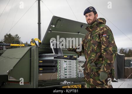 Dutch Sergeant Noordermeer checking the RACE 1 equipment. 1 German/Netherlands Corps' Communication and Information Systems Battalion is responsible for the communication between the Headquarters and its brigades. RACE 1 provides the CIS link between 1GNC as LCC and the Italian Ariete Brigade for Exercise Trident Juncture.    With around 50,000 personnel participating in Trident Juncture 2018, it is one of the largest NATO exercises in recent years. Around 250 aircraft, 65 vessels and more than 10,000 vehicles are involved in the exercise in Norway. Stock Photo