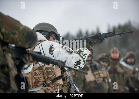 Belgian and German soldiers of the Very High Readiness Joint Task Force train their weapons proficiency in Norway during Exercise Trident Juncture. During Exercise Trident Juncture 2018 in Norway they are certified for this task. Some 50.000 troops, 10.000 vehicles, 250 aircraft and 65 ships from 30 NATO Nations take part. Stock Photo