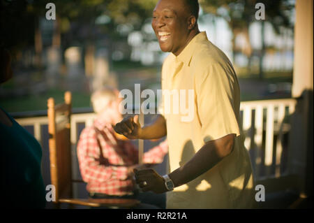 Mid-adult man dancing and having fun with friends. Stock Photo