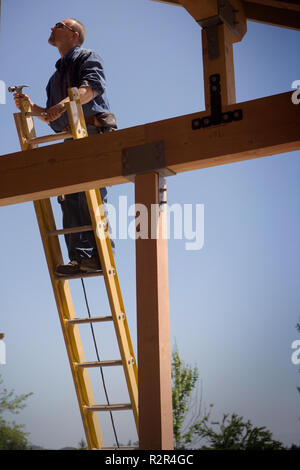 Focused builder working on a construction site. Stock Photo