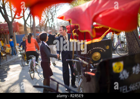 Mid-adult businessman shaking hands with a female colleague on the street. Stock Photo