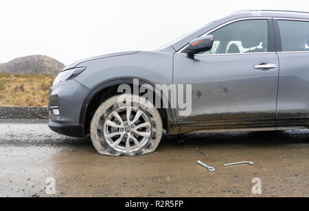 View of a car with flat tire Stock Photo