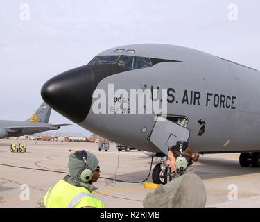 Senior Airmen Leslie Whitfield and Nikki Anderson prepare to launach a KC-135 Stratotanker at Selfridge Air National Guard Base, Mich., Nov. 4, 2018. Lt. Col. Leah Voelker, the aircraft commander for this flight, can be seen sitting at the pilot's controls inside the aircraft. The KC-135 is used for air-to-air refueling, cargo and passenger lift and can be configured to transport medical patients. Stock Photo