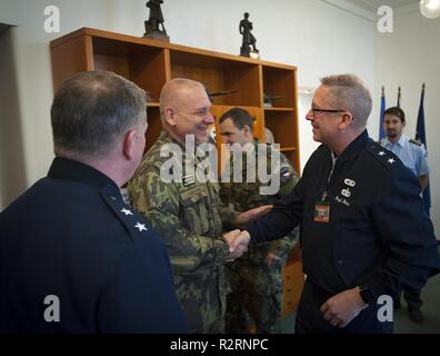Maj. Gen. Daryl Bohac, Nebraska adjutant general, greets Czech Lt. Gen. Jiri Baloun, first deputy chief of the Czech General Staff, during a visit to the Czech Ministry of Defense on Oct. 26 in Prague, Czech Republic. Also pictured is Maj. Gen. John Nichols, Texas adjutant general. The two Midwestern National Guard generals were the Czechs’ invited guests during their Oct. 27-28 celebration of the 100th anniversary of the founding of Czechoslovakia in October 1918. This also marks the 25th anniversary of the founding of the State Partnership Program relationship between the two Midwestern Nati Stock Photo