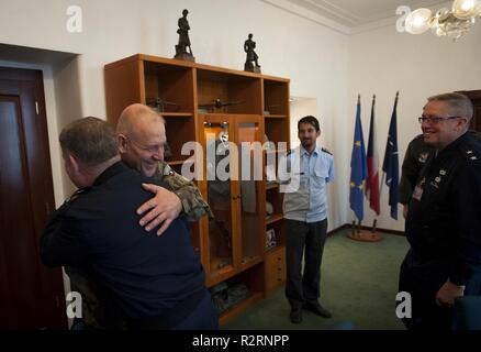 Maj. Gen. John Nichols, Texas adjutant general, exchanges greetings and hugs with Czech Lt. Gen. Jiri Baloun, first deputy chief of the Czech General Staff, during a visit to the Czech Ministry of Defense on Oct. 26 in Prague, Czech Republic. Also pictured is Maj. Gen. Daryl Bohac, Nebraska adjutant general. The two Midwestern National Guard generals were the Czechs’ invited guests during the Oct. 27-28 celebration of the 100th anniversary of the founding of Czechoslovakia in October 1918. This also marks the 25th anniversary of the founding of the State Partnership Program relationship betwee Stock Photo
