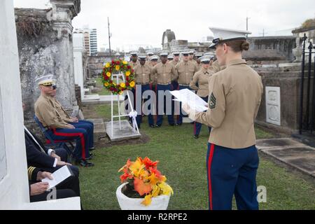 Gunnery Sgt. Emilie B. Osterfeld, administration chief with Marine Forces Reserve, narrates at the gravesite of Marine Corps Maj. Daniel Carmick during a wreath laying ceremony at St. Louis Cemetery No. 2 in New Orleans, Nov. 6, 2018. This ceremony is held annually to celebrate and honor the legacy and actions of Maj. Carmick during the Battle of New Orleans during the War of 1812. Maj. Carmick’s leadership on the battlefield was an essential contribution that resulted in the defeat of British troops and prevented the seizure and conquest of the Louisiana territory. Stock Photo