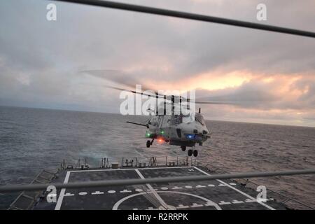 A Royal Netherlands Navy NH90 lands on Spanish frigate ESPS Cristóbal Colón in the North Atlantic during NATO exercise Trident Juncture 2018.    Trident Juncture 2018 is NATO’s largest exercise in many years, bringing together around 50,000 personnel from all 29 Allies, plus partners Finland and Sweden. Around 65 vessels, 250 aircraft and 10,000 vehicles will participate. Stock Photo