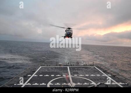 A Royal Netherlands Navy NH90 lands on Spanish frigate ESPS Cristóbal Colón in the North Atlantic during NATO exercise Trident Juncture 2018.     Trident Juncture 2018 is NATO’s largest exercise in many years, bringing together around 50,000 personnel from all 29 Allies, plus partners Finland and Sweden. Around 65 vessels, 250 aircraft and 10,000 vehicles will participate. Stock Photo