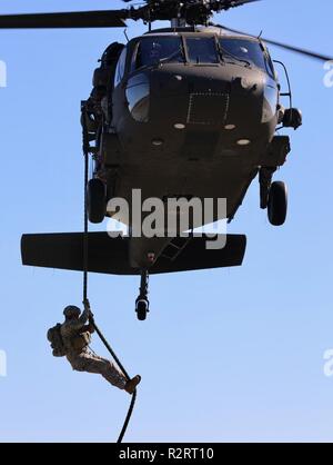 U.S. Army Ranger soldiers fast rope from a USA UH-60 Black Hawk ...