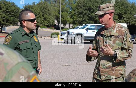 Agent Moreno from U.S. Customs and Border Patrol and Cpt. Charles O. Matthews, 104th Engineer Construction Company, discuss plans for Soldiers installing concertina wire along the Arizona and Mexico border on Nov. 6, 2018. U.S. Northern Command is providing military support to the Department of Homeland Security and U.S. Customs and Border Protection to secure the southern border of the United States. Stock Photo