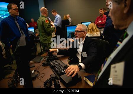 A Personalized Learning Cohort member flies a pilot training simulator during a visit to Luke Air Force Base, Ariz., Nov. 2, 2018. Throughout the tour, members of the cohort were given the opportunity to speak with Airmen and receive a comprehensive review of some of the resources and tools used to train fighter pilots. Stock Photo
