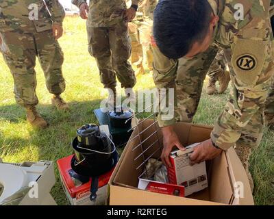 SAIPAN, Commonwealth of the Northern Mariana Islands – A Soldier with the 797th Engineer Company (Vertical), 9th Mission Support Command, goes through an accessories box for Federal Emergency Management Agency (FEMA) tents at the Koblerville Fire Station in Saipan, Commwealth of the Northern Mariana Islands, Nov. 7. The Soldiers spent a day learning all the tent components and how to set it up. Service members from Joint Region Marianas and other units from within Indo-Pacific Command assigned to Task Force-West are providing Department of Defense support to the CNMI’s civil and local official Stock Photo