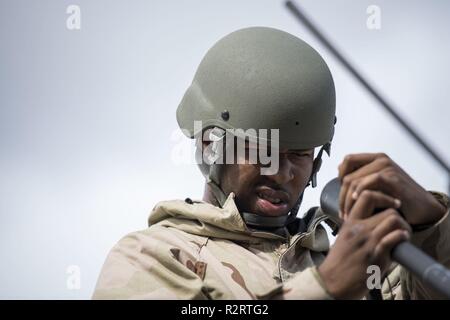 Navy personnel erect a communications antenna during Operation URGENT ...