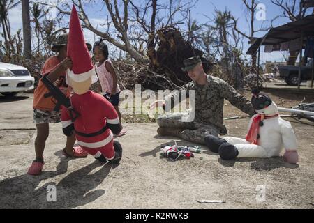 Staff Sgt. Joseph Colvin, an ammunition technician with Combat Logistics Battalion 31, speaks with Tinian residents during U.S. Defense Support of Civil Authorities relief efforts on Tinian, Commonwealth of the Northern Mariana Islands, Nov. 6, 2018. Colvin, a native of, Croydon, Pennsylvania, graduated from Bucks County Technical High School in June 2006 before enlisting in August 2007. Businesses, government buildings, homes and schools were heavily damaged by Super Typhoon Yutu, which made a direct hit with devastating effect on Tinian Oct. 25 as the second strongest storm to ever hit U.S.  Stock Photo