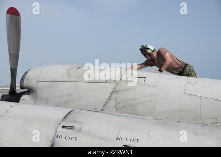 U.S. 5TH FLEET AREA OF OPERATIONS (Nov. 6, 2018) Aviation Structural Mechanic 2nd Class Ryan Pettis, assigned to the “Grey Knights” of Patrol Squadron (VP) 46, covers an air intake on a P-3C Orion anti-submarine warfare patrol aircraft after a maintenance check. VP-46 is currently deployed to the U.S. 5th Fleet and U.S. 7th Fleet areas of operations in support of Operation Inherent Resolve. While in this region, VP-46 is supporting naval operations to ensure maritime stability and security in the Central Region, connecting the Mediterranean and the Pacific through the western Indian Ocean and  Stock Photo