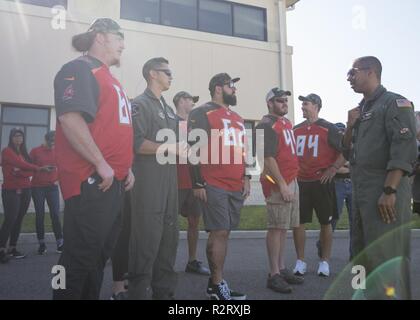U.S. Air Force Capt. Stephen Kemp, a KC-135 Stratotanker pilot assigned to the 91st Air Refueling Squadron, talks with Tampa Bay Buccaneers football players at MacDill Air Force Base, Fla., Oct 30, 2018. The Buccaneers toured a KC-135 Stratotanker static display, visited U.S. Central Command and spent time with the 6th Security Forces Squadron defenders during their visit to MacDill. Stock Photo