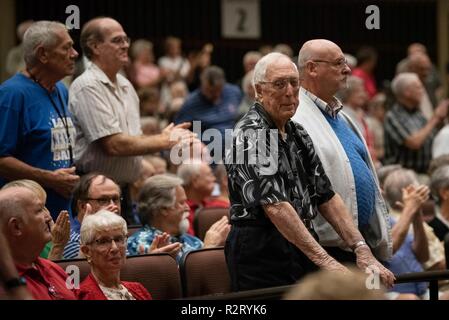 LAKELAND, Fla. (Nov. 7, 2018) Lloyd Van Horn, a 100-year old WWII veteran, stands with other Navy veterans during the playing of 'Anchors Aweigh' at the Commodores concert at the RP Funding Center. Every concert performed by the Commodores ends with a salute to the armed forces, in which veterans from all service branches are honored. The Commodores are on a 22-day tour of the southeastern United States, connecting communities to the Navy and building awareness and support for the Navy. Stock Photo