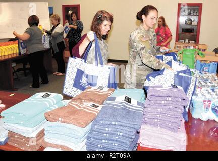 First Lt. Sara Johnson, 573rd Engineer Company, 46th Engineer Battalion rear detachment commander (right) and Tracy Kerlin, an employee at Barksdale Federal Credit Union, pack bags for single Soldiers assigned to the 573rd Eng Co returning from a nine-month deployment to Iraq. Stock Photo