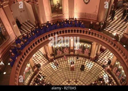 The Imlay City High School Choir sings above World War I commemoration ceremony organized by the Michigan World War I Commission was held Nov. 8, 2018, in the Michigan State Capitol rotunda in Lansing, Michigan. The Michigan State Capitol, opened in 1879, was one of the first state capitols to be topped by a lofty cast iron dome, below which the choir sang. Stock Photo