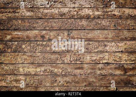 Texture of old brown wooden wall with cracked paint. Structure of painted weathered vintage surface. Stock Photo