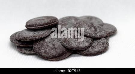 Dark edged chocolate chips isolated over white background Stock Photo