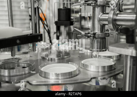 production and bottling of yogurt in plastic cups. equipment at the dairy plant Stock Photo