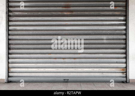 Closed garage entrance, rusted metal roll gate, flat background photo texture Stock Photo