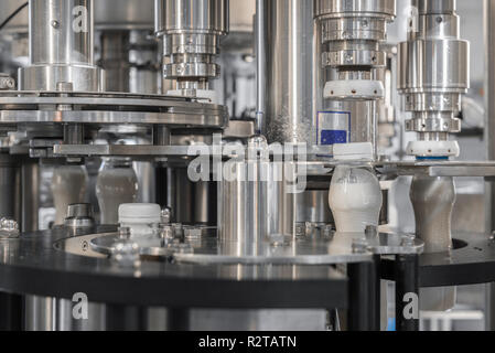 filling milk in to plastic bottles at the factory. equipment at the dairy plant Stock Photo